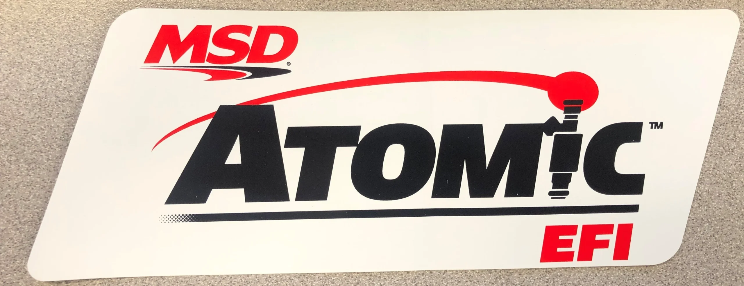 The MSD ATOMIC EFI Logo Decal; Red, Black & White. 9.25" wide x 3.375" high.